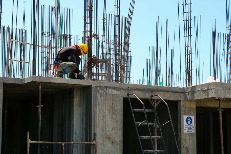 Bricklayers talking on an indoor construction site